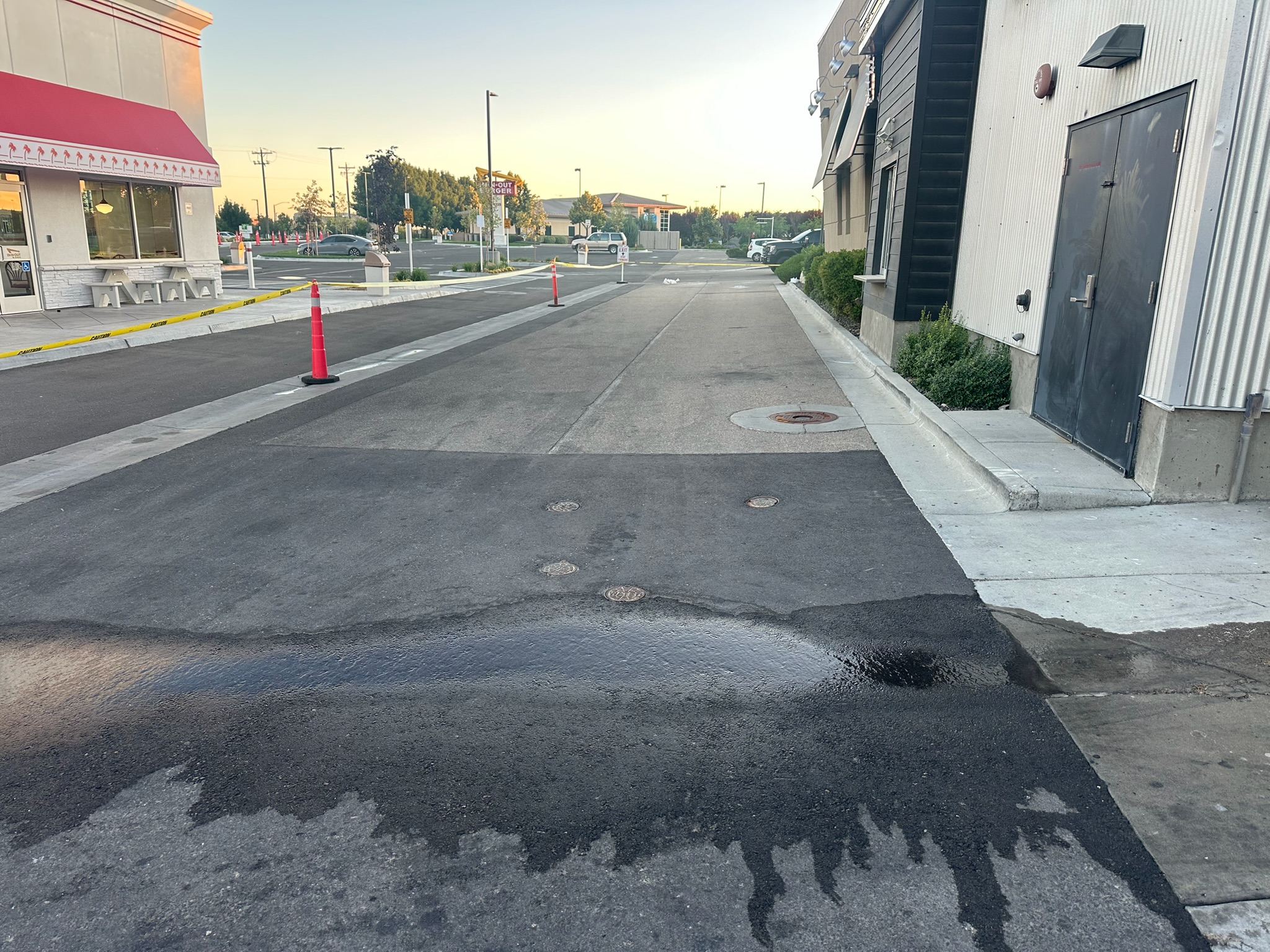 Pothole damage on a commercial parking lot before asphalt repair by Supreme Seal Coat