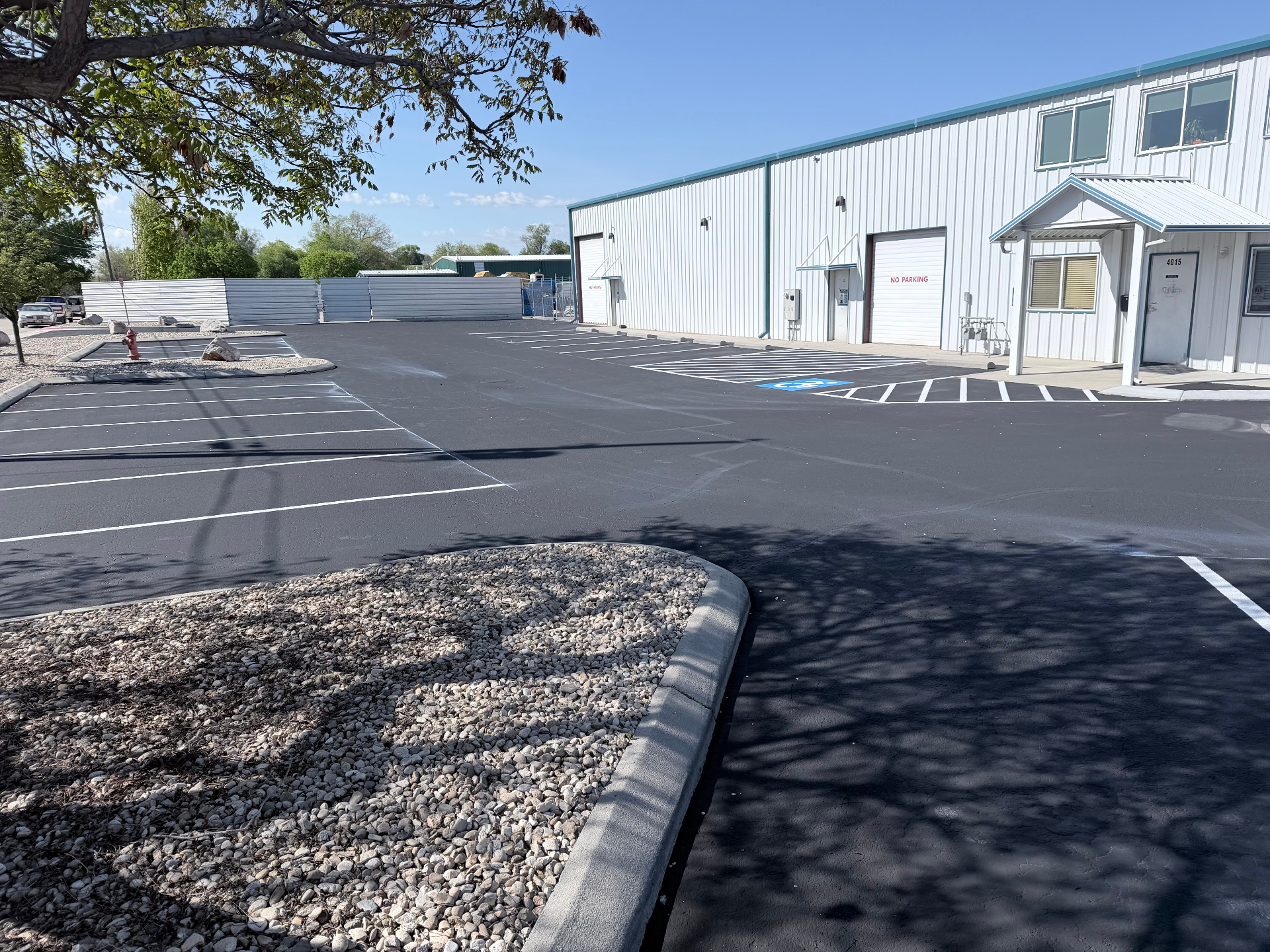 Commercial parking lot front view after sealcoating with fresh ADA-compliant striping by Supreme Seal Coat
