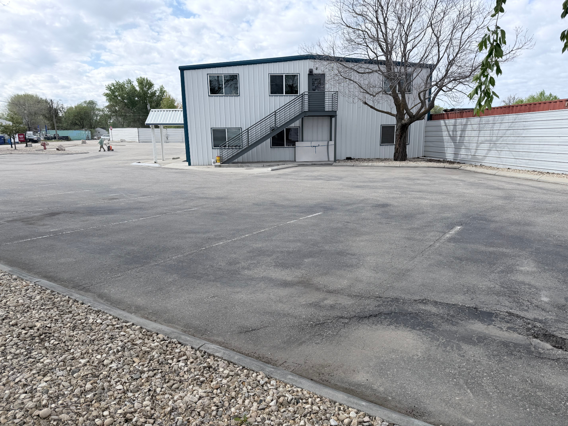 Two-story commercial building with parking lot before sealcoating