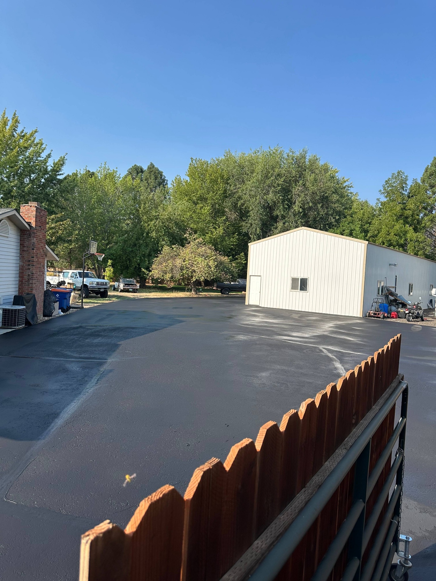 Large residential back lot freshly sealcoated by Supreme Seal Coat