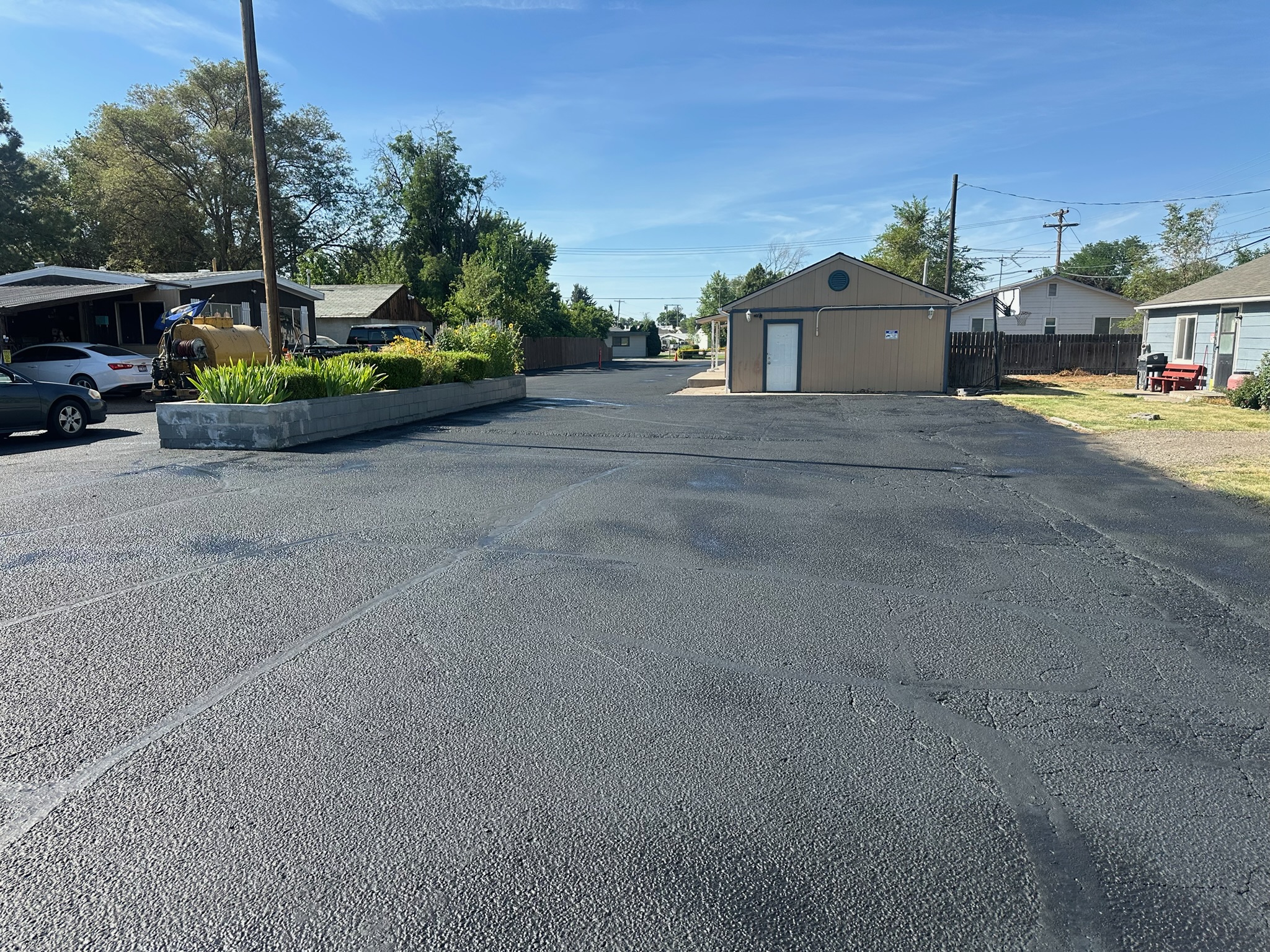 Residential driveway with garage freshly sealcoated by Supreme Seal Coat in the Treasure Valley