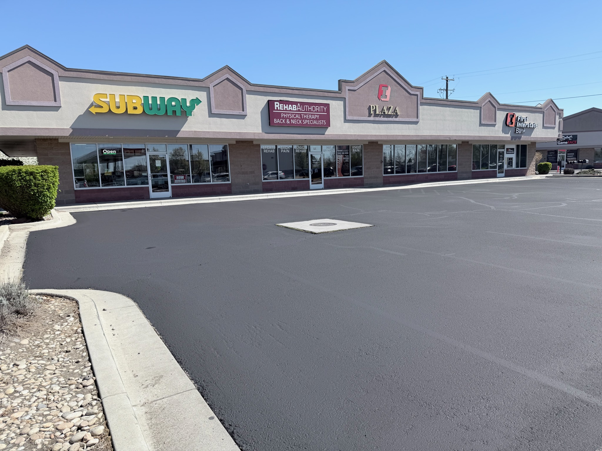 Storefront view of the multi-tenant Meridian plaza after striping