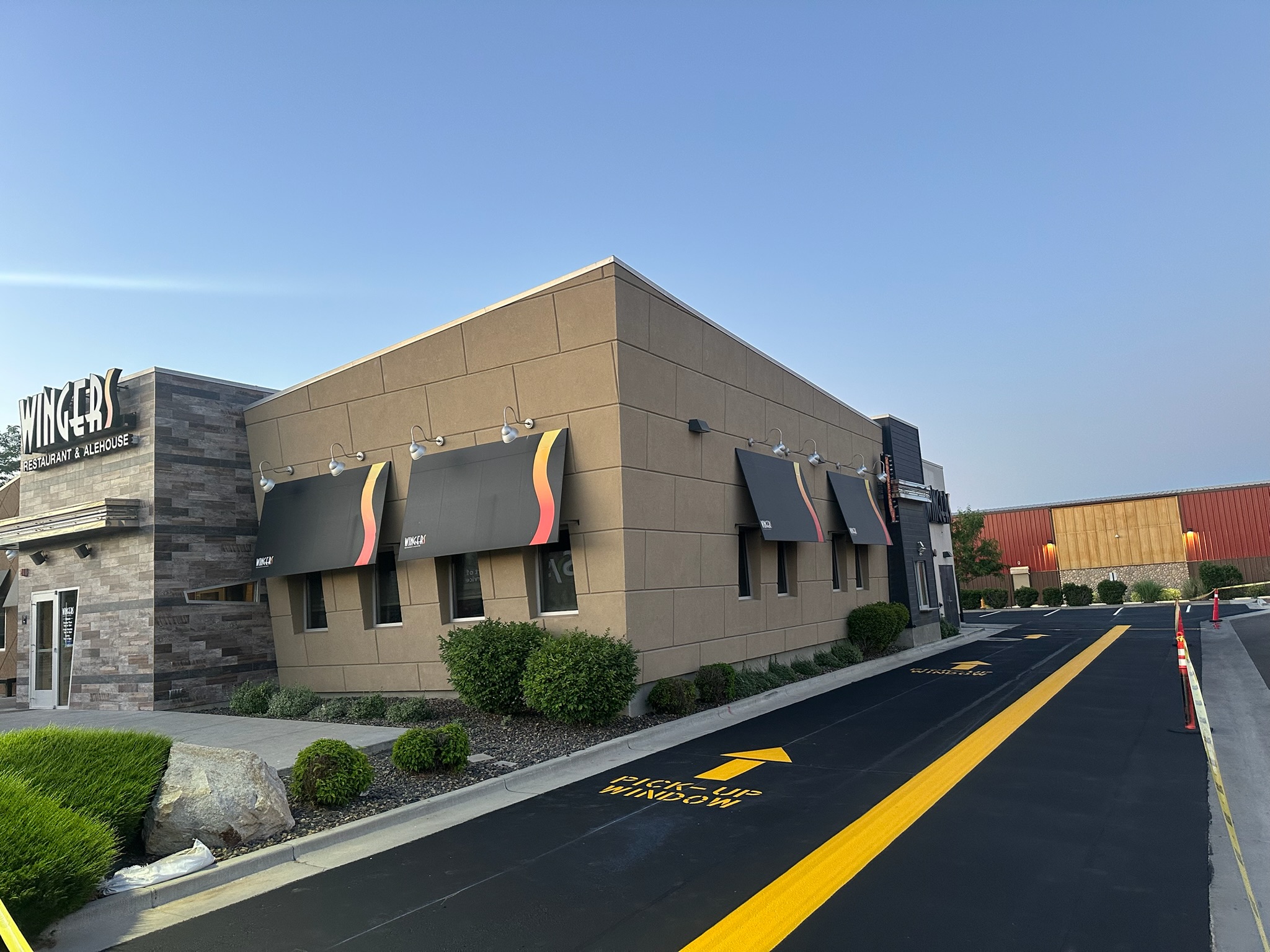 Drive-through directional striping and pick-up window markings at Wingers Restaurant in Meridian, Idaho by Supreme Seal Coat
